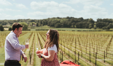 Couple enjoying wine on balcony at Balfour Winery