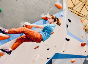 Woman climbing on the Climbing Experience Wall